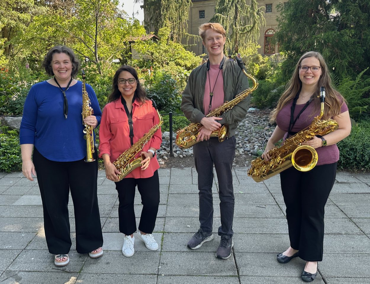 The members of HyperResonance standing outdoors with their saxophones